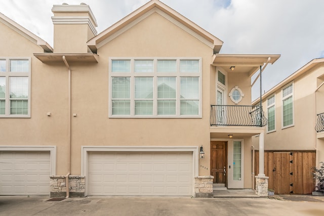 view of property featuring a balcony and a garage