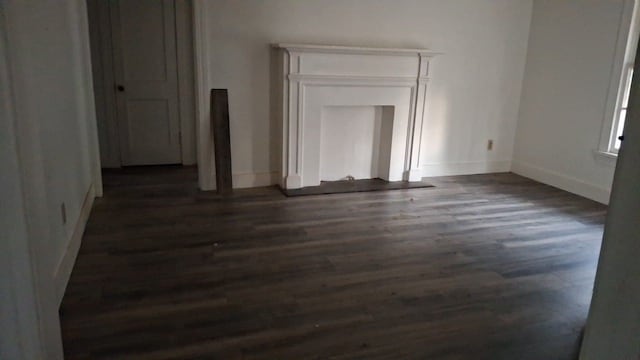 unfurnished living room featuring dark hardwood / wood-style floors