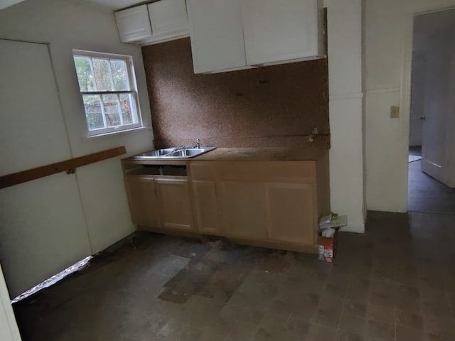 kitchen featuring white cabinetry, sink, and backsplash