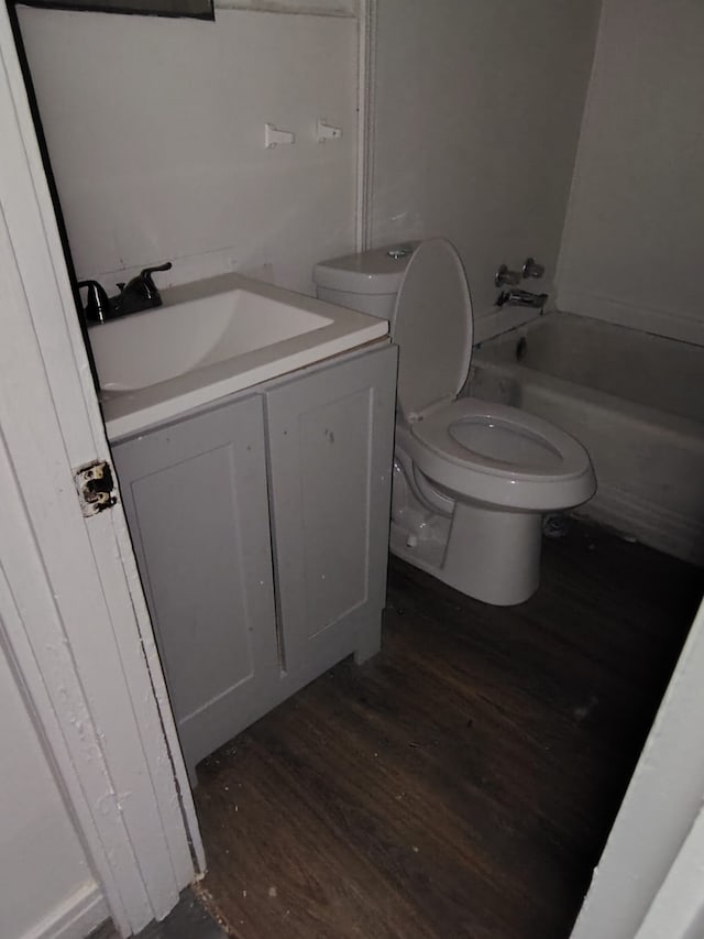 bathroom with hardwood / wood-style flooring, vanity, and toilet