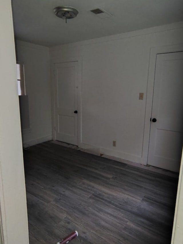 spare room with dark wood-type flooring