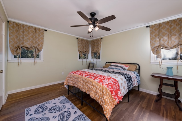 bedroom with dark hardwood / wood-style flooring, ornamental molding, and ceiling fan