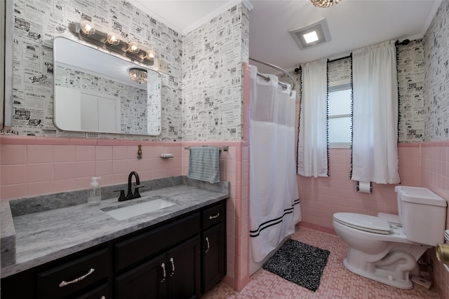 bathroom with tile walls, curtained shower, vanity, and toilet