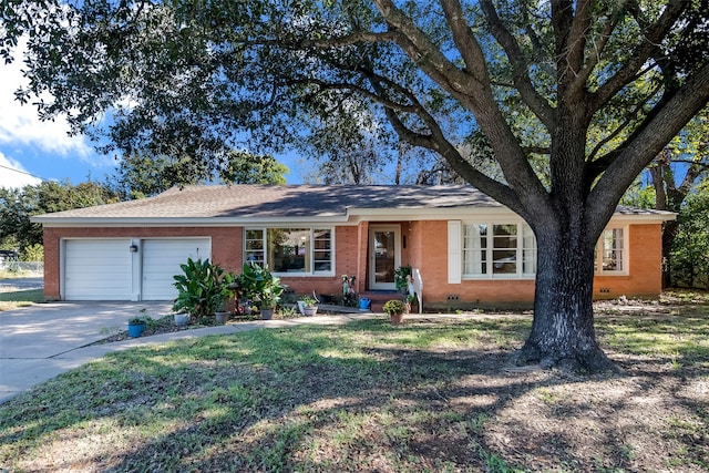 ranch-style home with a garage and a front lawn