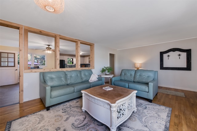 living room featuring hardwood / wood-style floors and ceiling fan