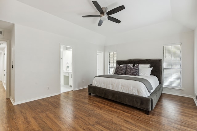 bedroom featuring multiple windows, ensuite bath, lofted ceiling, and dark hardwood / wood-style flooring