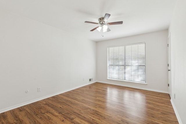 spare room with hardwood / wood-style floors and ceiling fan