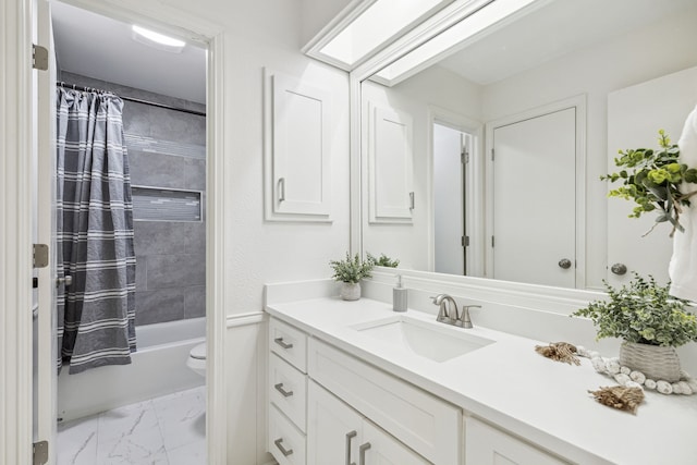 full bathroom featuring vanity, shower / bath combo with shower curtain, and toilet