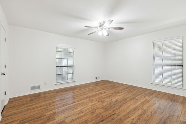 spare room with ceiling fan and wood-type flooring