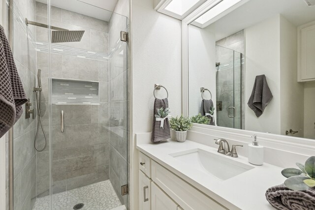 bathroom with vanity and a shower with door