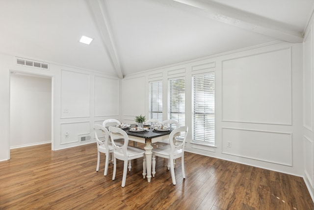 dining room featuring lofted ceiling with beams and dark wood-type flooring