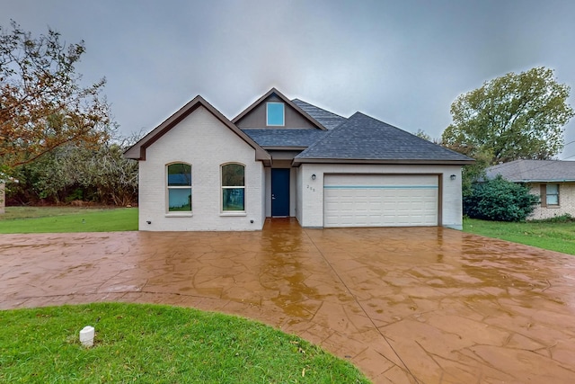 view of front of home with a garage and a front yard