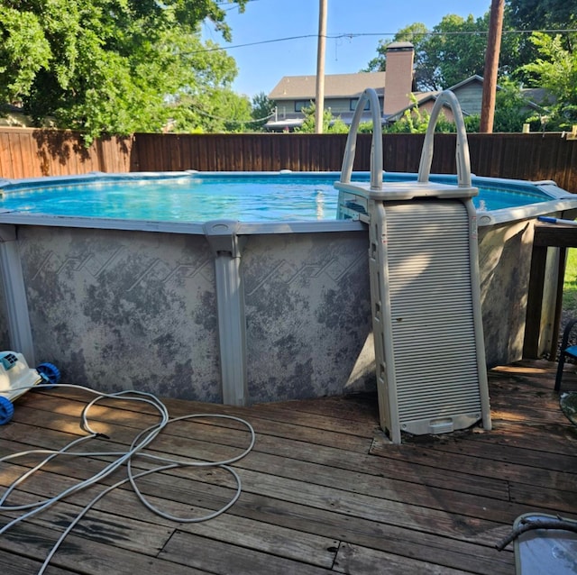 view of swimming pool with a deck