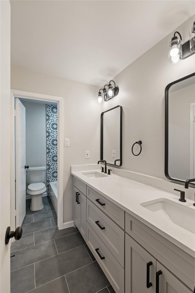 bathroom featuring vanity, toilet, and tile patterned flooring