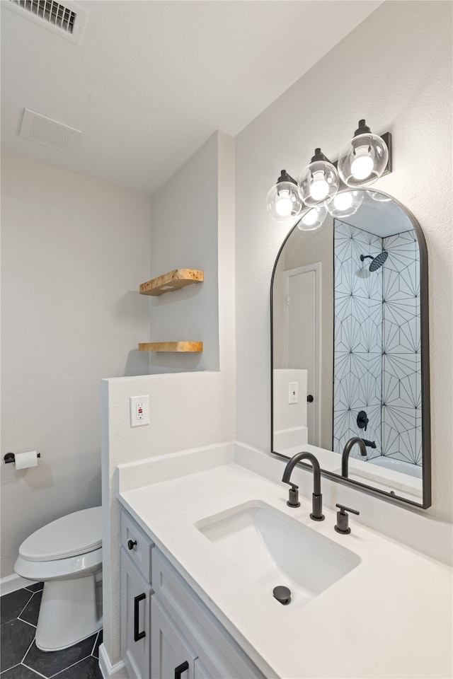 bathroom with vanity, toilet, and tile patterned flooring