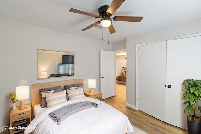 clothes washing area featuring washer hookup, hookup for an electric dryer, and light hardwood / wood-style flooring