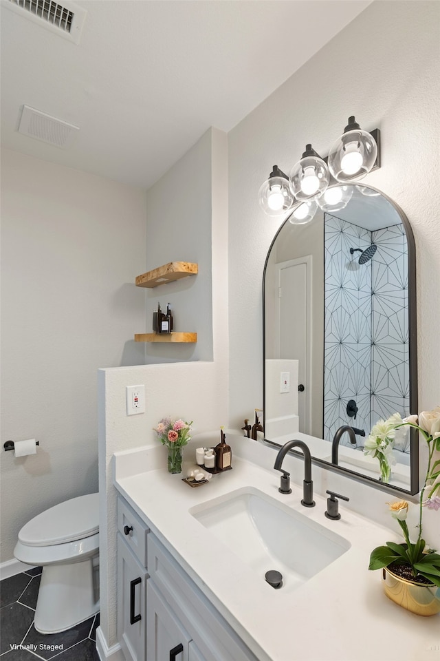 bathroom with vanity, walk in shower, tile patterned floors, and toilet