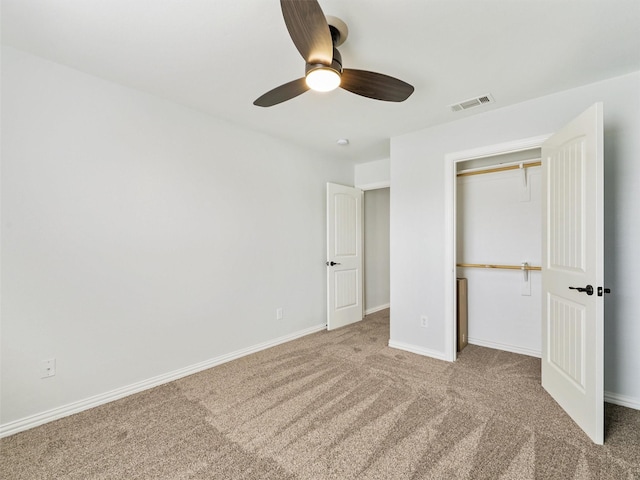 unfurnished bedroom with light carpet, ceiling fan, and a closet