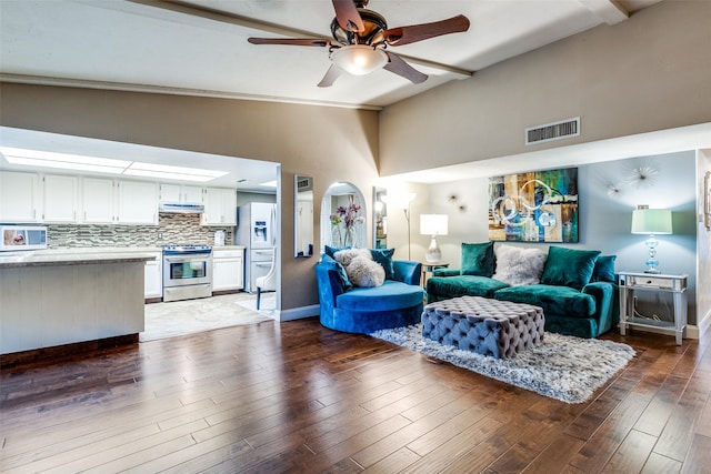 living room with high vaulted ceiling, dark wood-type flooring, and ceiling fan