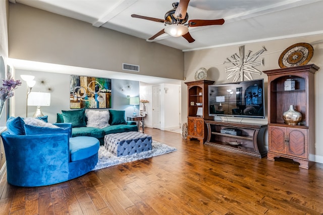 living room featuring ceiling fan, a towering ceiling, wood-type flooring, and beam ceiling