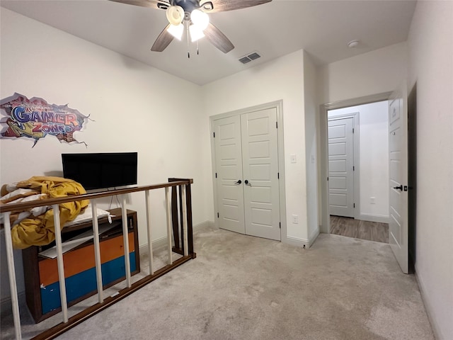 bedroom with ceiling fan and light colored carpet