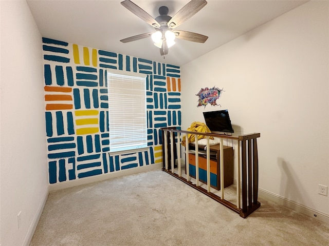 carpeted bedroom with a nursery area and ceiling fan