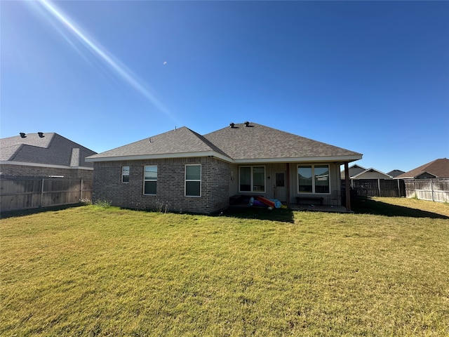 back of house with a yard