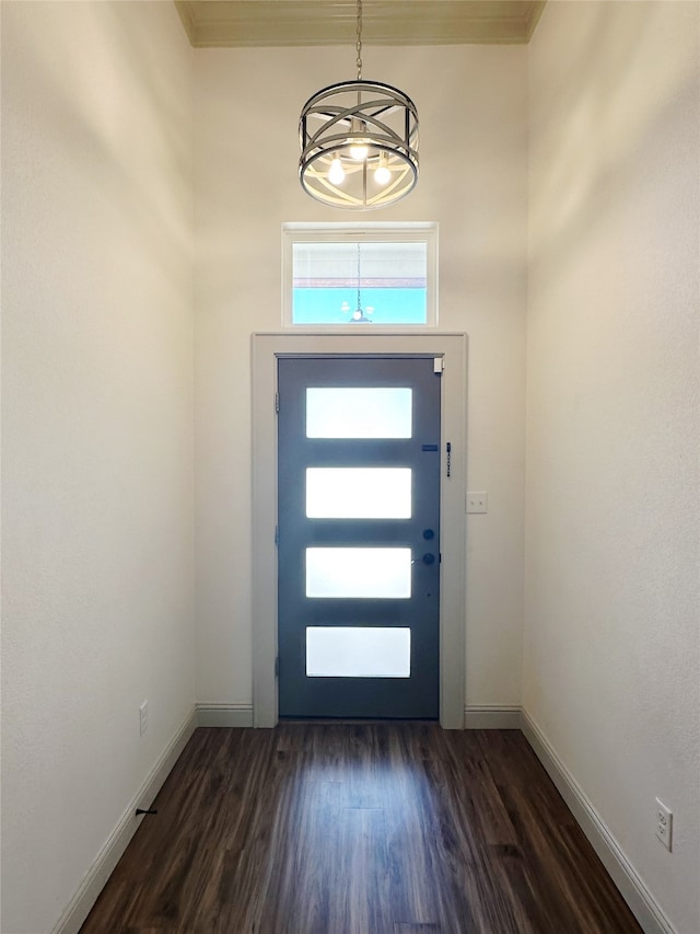 foyer featuring dark hardwood / wood-style flooring and an inviting chandelier