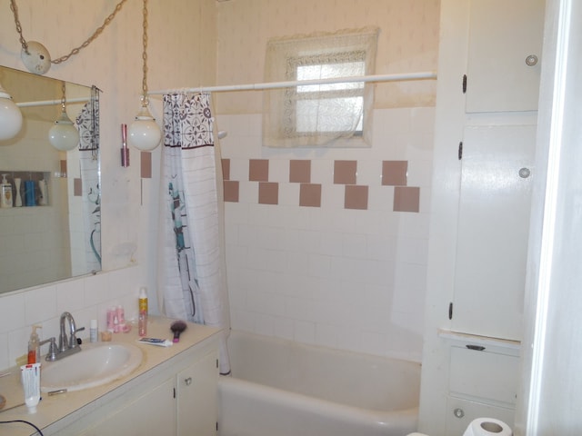 bathroom featuring backsplash, vanity, and shower / bathtub combination with curtain