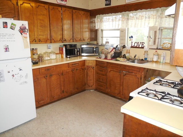 kitchen with sink and white fridge