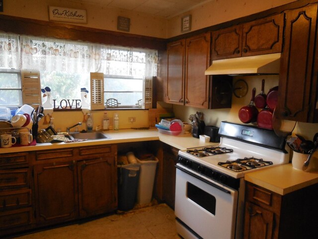 kitchen featuring sink and white gas stove