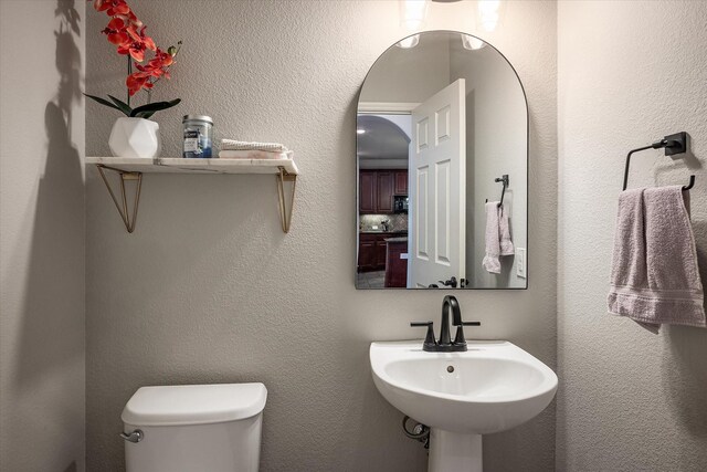 bathroom featuring sink and toilet