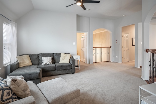 living room with ceiling fan, light carpet, and lofted ceiling