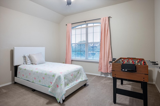 carpeted bedroom with ceiling fan and vaulted ceiling