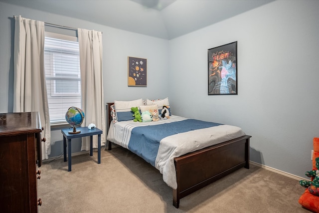 carpeted bedroom with lofted ceiling