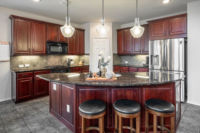 kitchen featuring a kitchen island, backsplash, and stainless steel fridge with ice dispenser