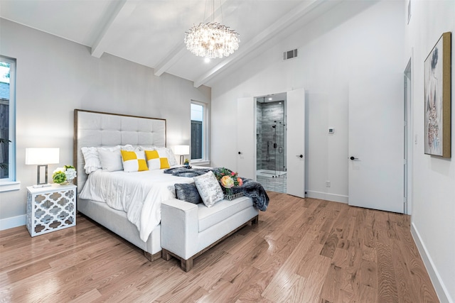 bedroom featuring ensuite bath, hardwood / wood-style floors, a notable chandelier, and vaulted ceiling with beams