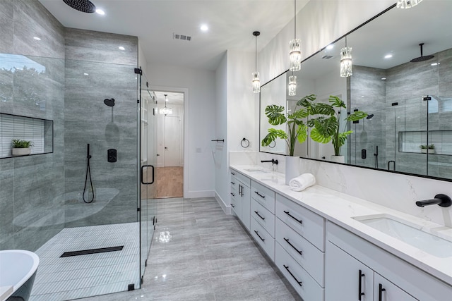 bathroom featuring vanity and separate shower and tub