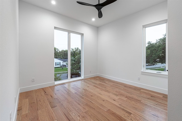 empty room with ceiling fan and light wood-type flooring