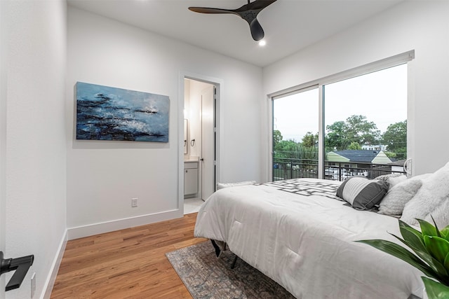 bedroom featuring connected bathroom, access to outside, light hardwood / wood-style flooring, and ceiling fan