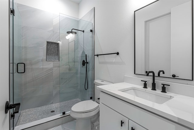 bathroom with vanity, toilet, and an enclosed shower