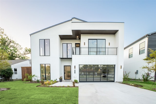 contemporary home featuring a front yard and a balcony