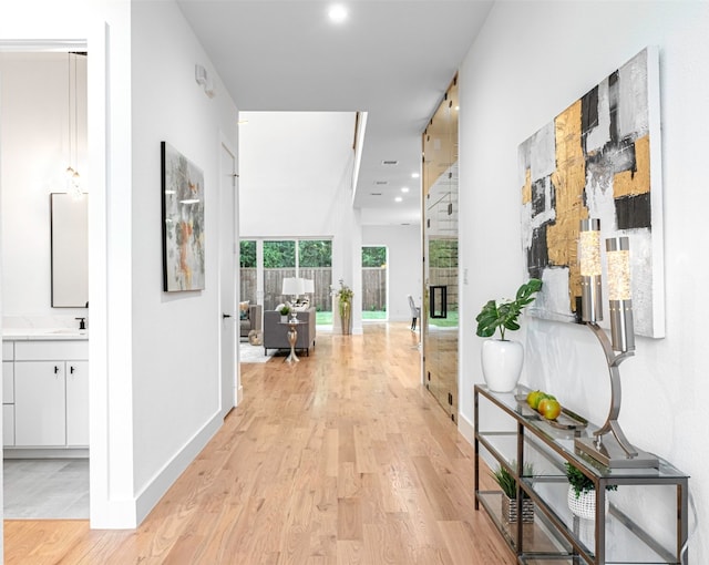 hall featuring light hardwood / wood-style flooring and sink