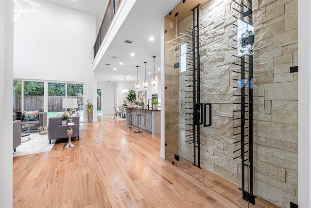 interior space with a high ceiling and light hardwood / wood-style flooring