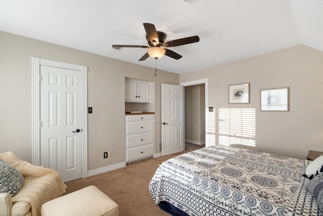 carpeted bedroom featuring vaulted ceiling and ceiling fan