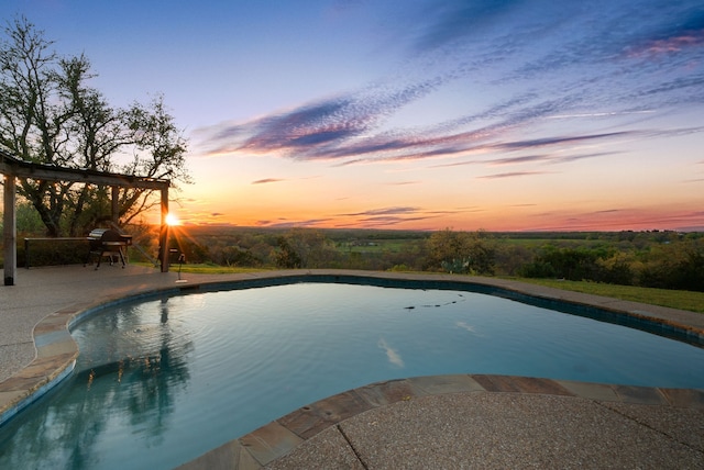 pool at dusk with a patio