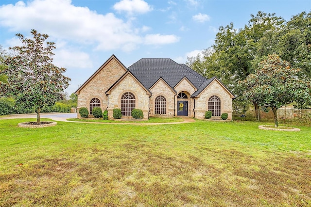 french country style house featuring a front yard