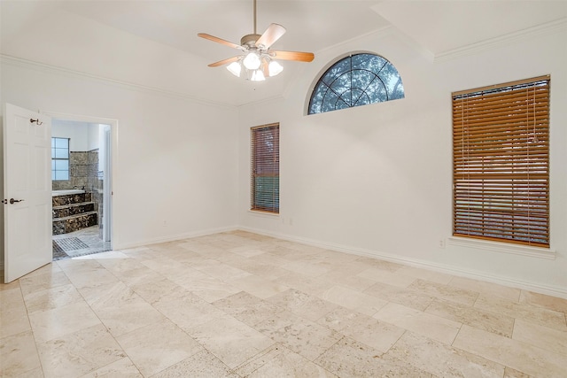 spare room featuring ceiling fan, a wealth of natural light, and ornamental molding