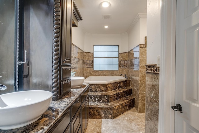 bathroom with vanity, tile walls, a relaxing tiled tub, and ornamental molding