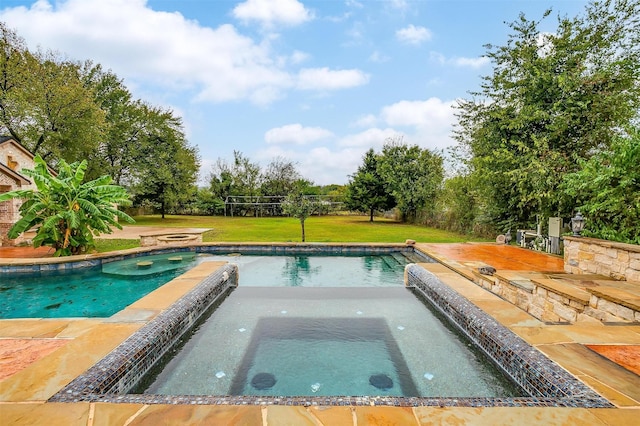 view of pool with an in ground hot tub and a lawn